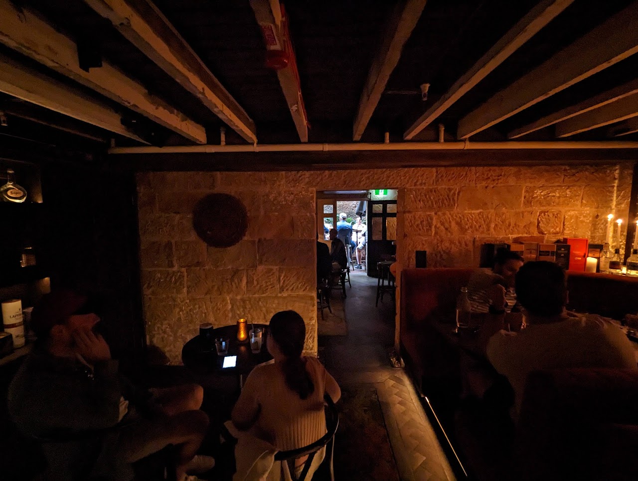 Guests seated in a dim underground room at The Doss House